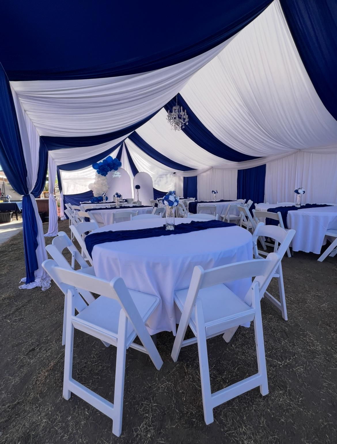 Blue and white draped event tent by Perez Party Rentals