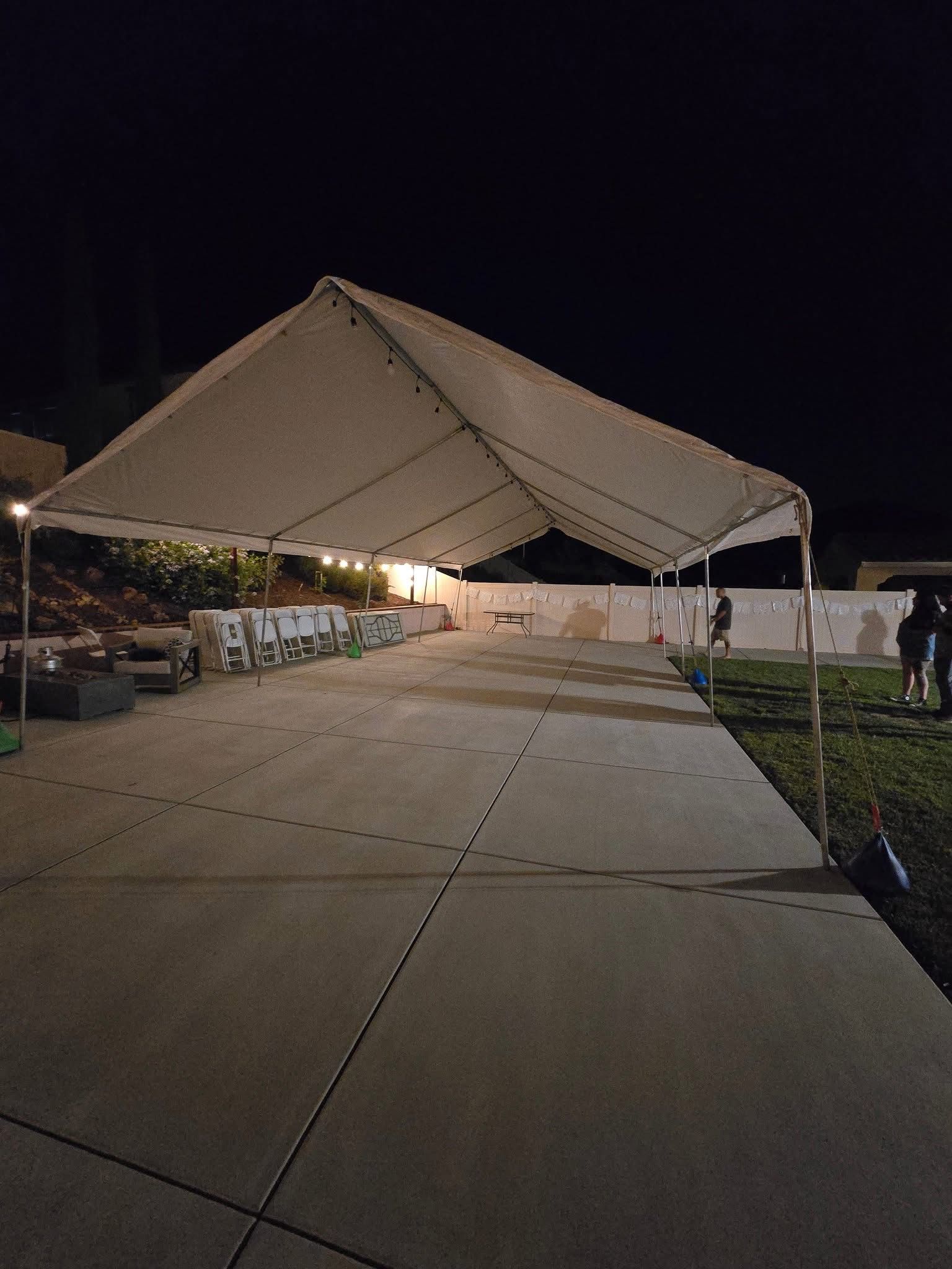 White party tent installed for an evening backyard event