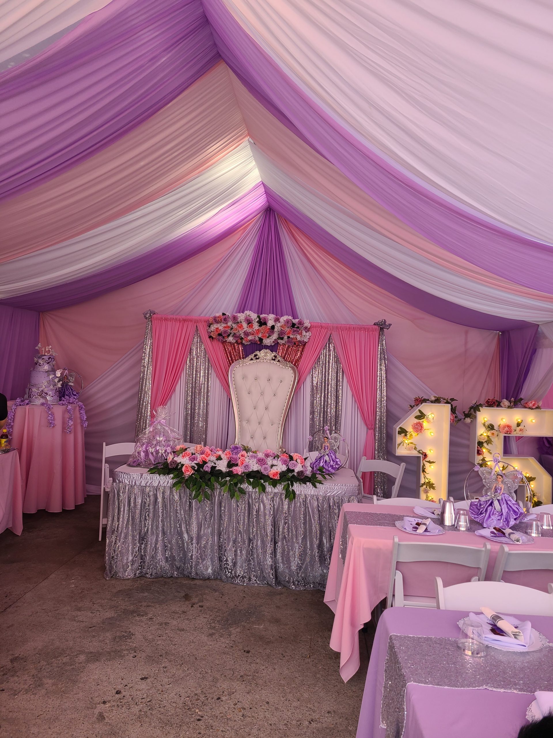 White throne chair at a pink and lavender event setup